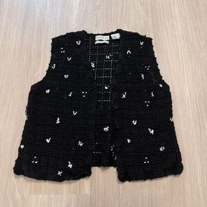 Black & white crochet vest with white detail accents